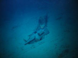 Stbd anchor embedded in steel plate from ship's side in debris field